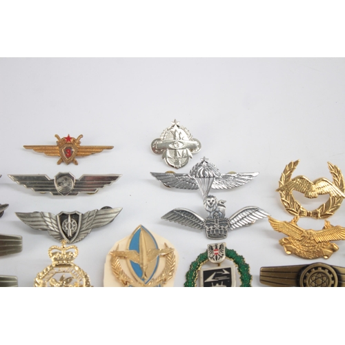 1250 - A collection of Air Force badges to include Austria, Angola, Hong Kong etc.