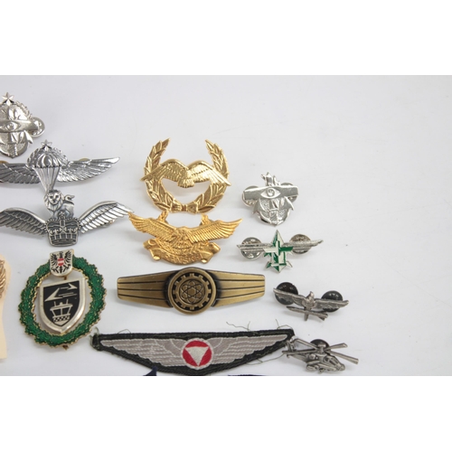 1250 - A collection of Air Force badges to include Austria, Angola, Hong Kong etc.