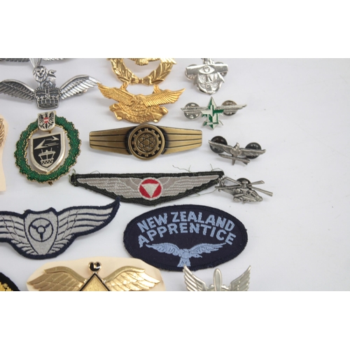 1250 - A collection of Air Force badges to include Austria, Angola, Hong Kong etc.