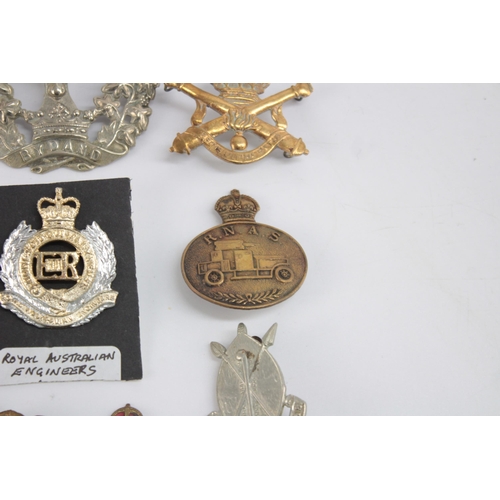 1262 - Ten military cap badges to include Women's Land Army, R.N.A.S etc.