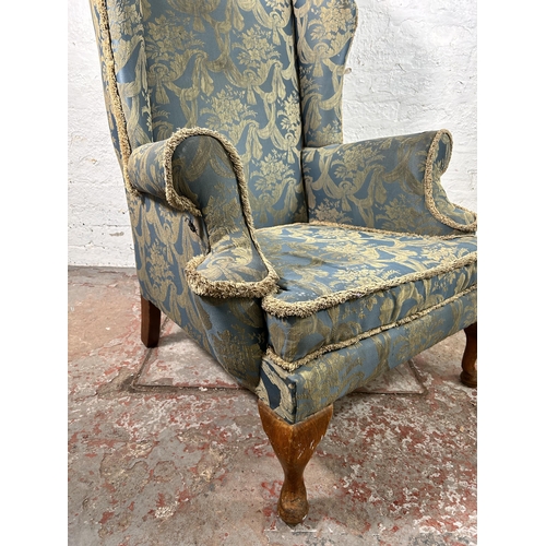 10 - A Georgian style fabric upholstered wingback armchair with cabriole supports