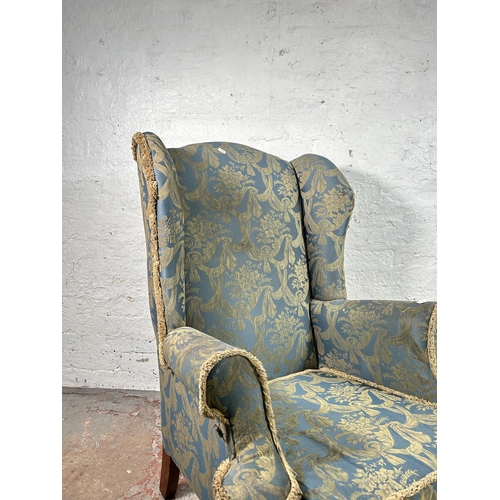 10 - A Georgian style fabric upholstered wingback armchair with cabriole supports