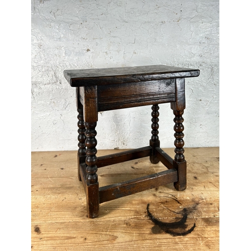 12 - A 17th century style oak joint stool with turned supports - approx. 45cm high x 39cm wide x 23cm dee... 