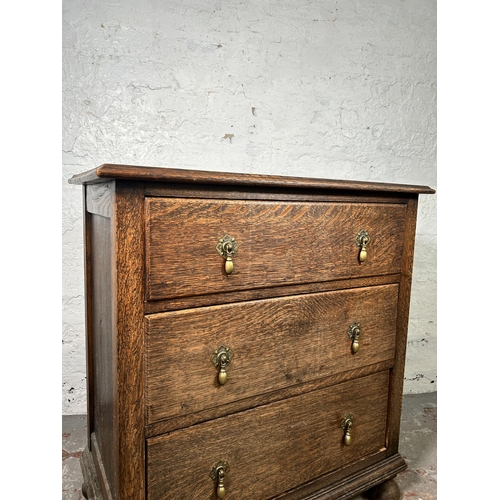 13 - An early 20th century oak chest of three drawers - approx. 82cm high x 75cm wide x 45cm deep