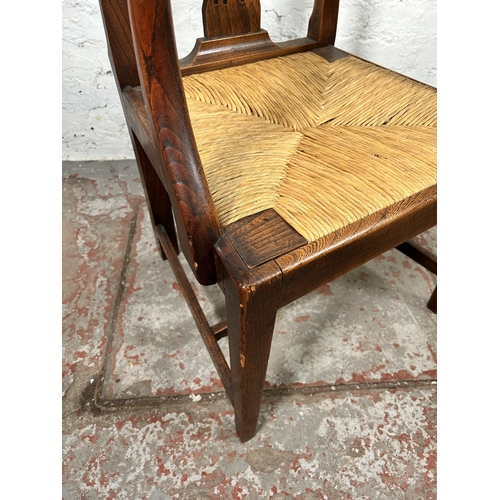 17 - A George III elm carver dining chair with later rush seat - approx. 98cm high x 59cm wide x 46cm dee... 