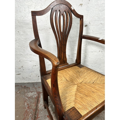 17 - A George III elm carver dining chair with later rush seat - approx. 98cm high x 59cm wide x 46cm dee... 