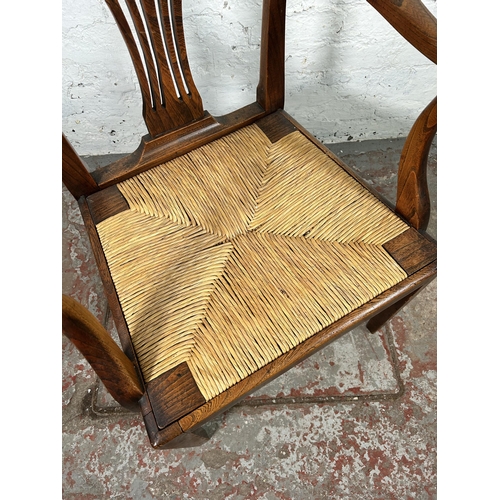 17 - A George III elm carver dining chair with later rush seat - approx. 98cm high x 59cm wide x 46cm dee... 