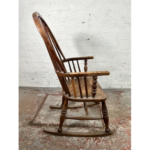 2 - A 19th century elm Windsor rocking chair - approx. 100cm high x 50cm wide x 38cm deep