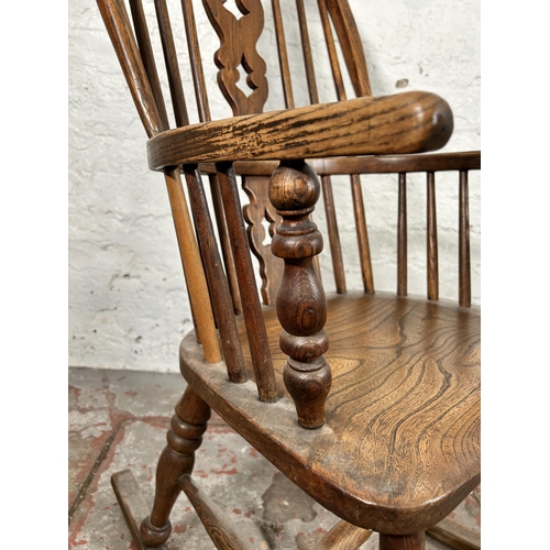 2 - A 19th century elm Windsor rocking chair - approx. 100cm high x 50cm wide x 38cm deep