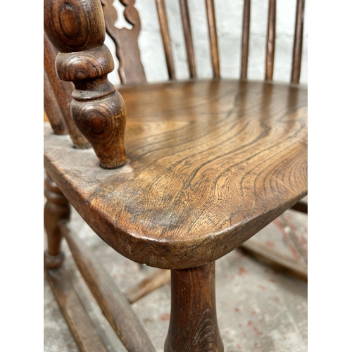 2 - A 19th century elm Windsor rocking chair - approx. 100cm high x 50cm wide x 38cm deep