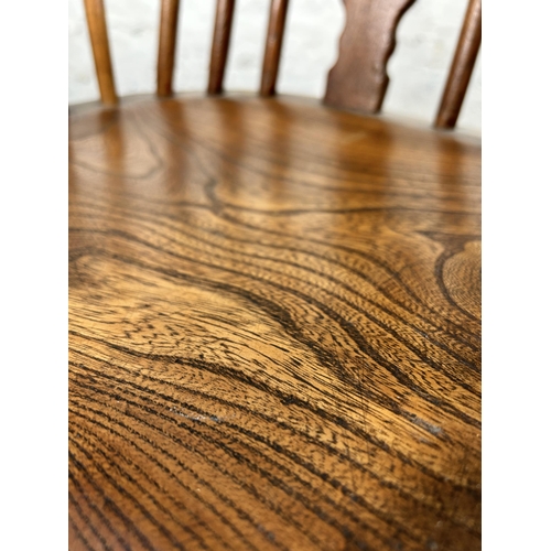 2 - A 19th century elm Windsor rocking chair - approx. 100cm high x 50cm wide x 38cm deep