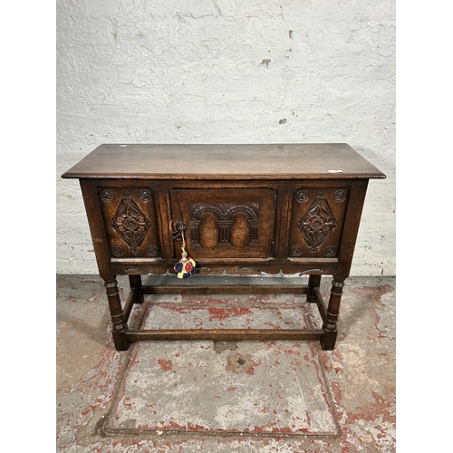 22 - A 17th century style carved oak single door cabinet - approx. 74cm high x 94cm wide x 35cm deep