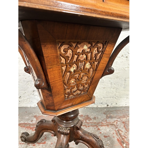 23 - A Victorian carved walnut sewing table on quatrefoil base - approx. 72cm high x 51cm wide x 40cm dee... 