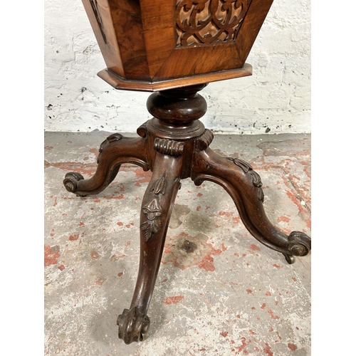 23 - A Victorian carved walnut sewing table on quatrefoil base - approx. 72cm high x 51cm wide x 40cm dee... 