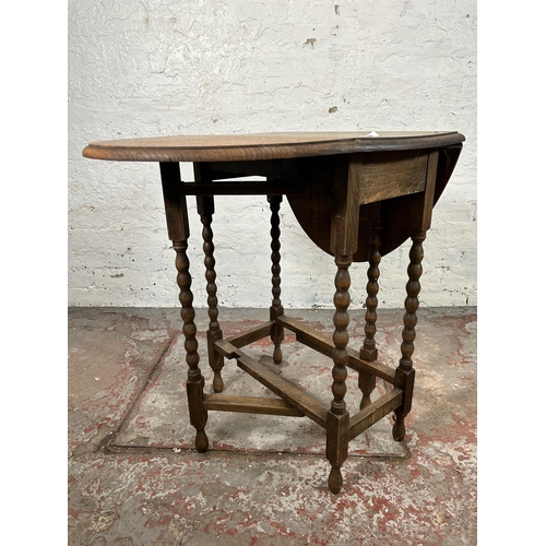 3 - An oak drop leaf gate leg oval occasional table on bobbin turned supports - approx. 74cm high x 60cm... 