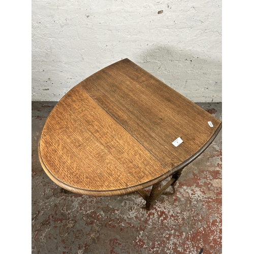 3 - An oak drop leaf gate leg oval occasional table on bobbin turned supports - approx. 74cm high x 60cm... 