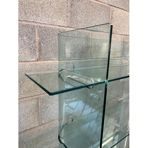 31 - A modern tempered glass four tier shelving unit - approx. 156cm high x 120cm wide x 40cm deep