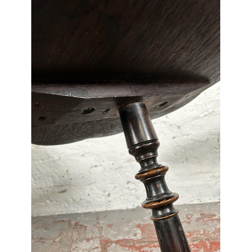 4 - A 19th century oak tripod occasional table - approx. 67cm high x 50cm diameter