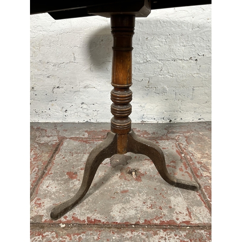 5 - A 19th century oak circular tilt top occasional table - approx. 117cm high x 78cm diameter