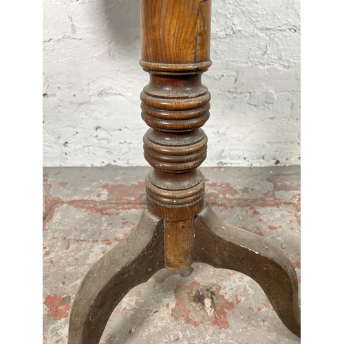 5 - A 19th century oak circular tilt top occasional table - approx. 117cm high x 78cm diameter