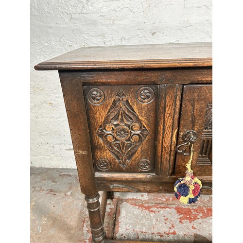 22 - A 17th century style carved oak single door cabinet - approx. 74cm high x 94cm wide x 35cm deep