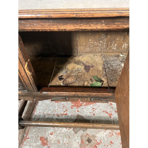 22 - A 17th century style carved oak single door cabinet - approx. 74cm high x 94cm wide x 35cm deep