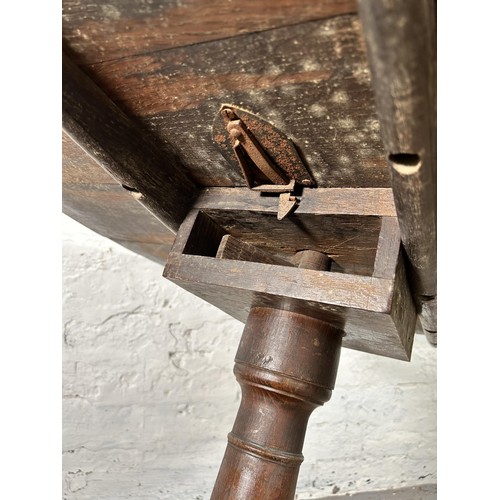 42 - A 19th century oak circular tilt top occasional table - approx. 71cm high x 78cm diameter