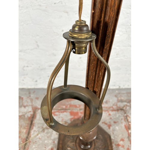 48 - A carved oak standard lamp - approx. 135cm high