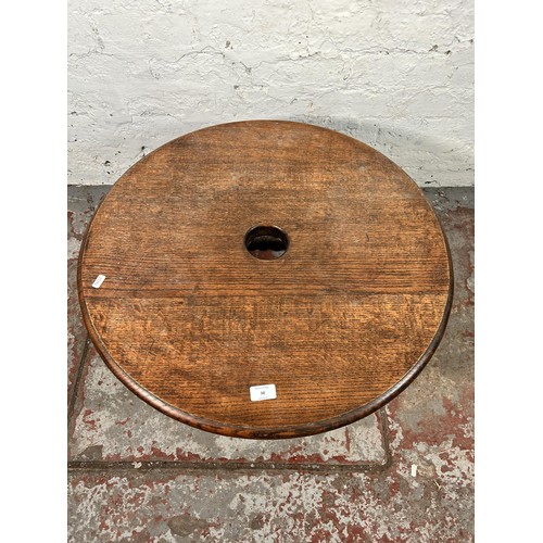 50 - A 17th century style oak circular side table with turned stretchers - approx. 39cm high x 69cm diame... 