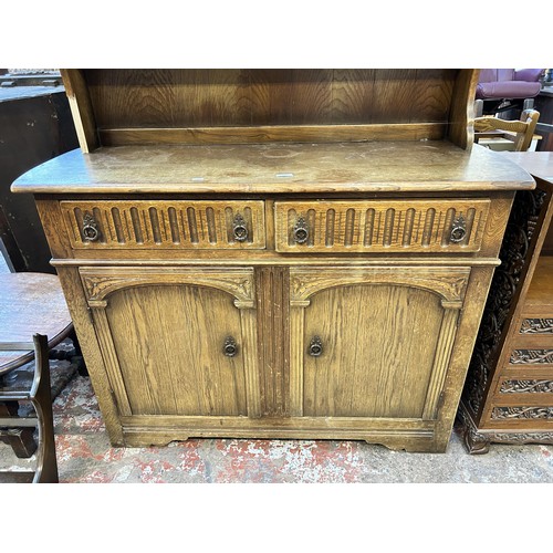 52 - A Priory style carved oak dresser - approx. 180cm high x 122cm wide x 47cm deep