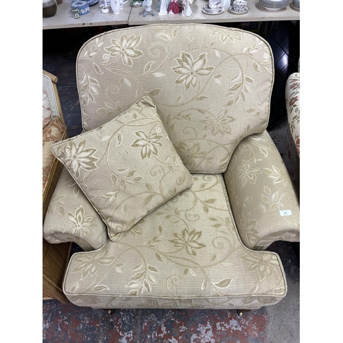 122 - A Regency style floral upholstered armchair with mahogany supports and brass castors - approx. 100cm... 