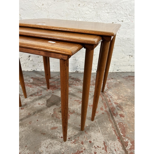 100 - A mid 20th century teak nest of three tables - approx. 49cm high x 55cm wide x 38cm deep