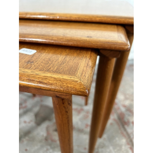 100 - A mid 20th century teak nest of three tables - approx. 49cm high x 55cm wide x 38cm deep