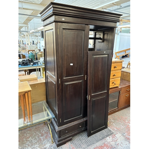 101 - A modern mahogany double wardrobe with two lower drawers