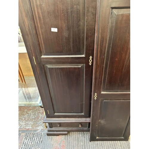 101 - A modern mahogany double wardrobe with two lower drawers