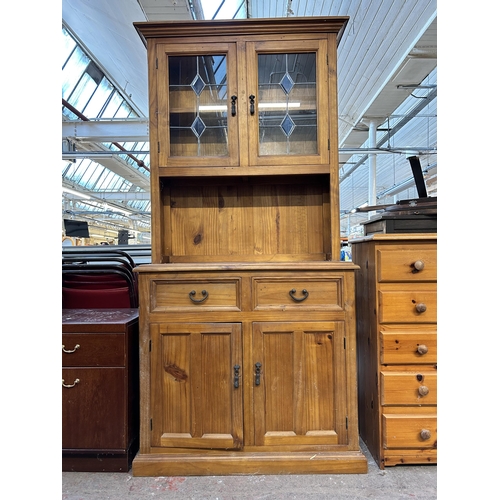 103 - A modern pine dresser with two upper leaded glass doors, two drawers and two lower cupboard doors - ... 