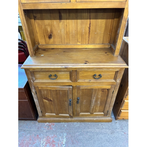 103 - A modern pine dresser with two upper leaded glass doors, two drawers and two lower cupboard doors - ... 