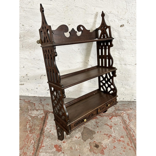 106 - A George III style carved mahogany wall mountable three tier shelf with two lower drawers - approx. ... 