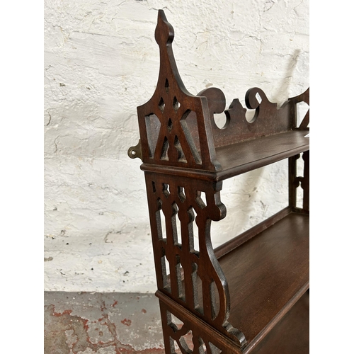 106 - A George III style carved mahogany wall mountable three tier shelf with two lower drawers - approx. ... 