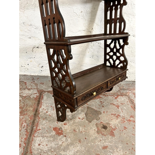 106 - A George III style carved mahogany wall mountable three tier shelf with two lower drawers - approx. ... 