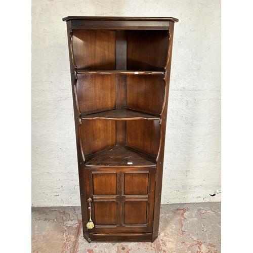 115 - An Ercol dark elm free standing corner cabinet