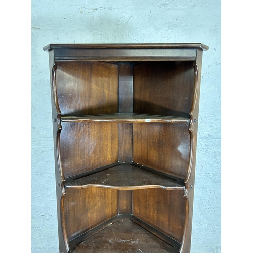 115 - An Ercol dark elm free standing corner cabinet