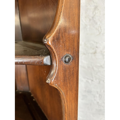 115 - An Ercol dark elm free standing corner cabinet