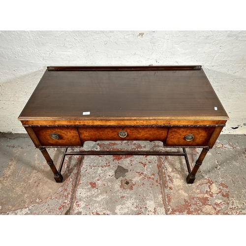 117 - A Waring & Gillow Ltd. walnut dressing table with three drawers, patent no. 224089 - approx. 77cm hi... 