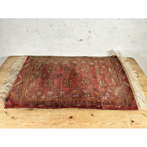 119 - A vintage Bokhara red rug - approx. 103cm x 70cm