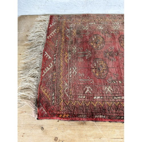 119 - A vintage Bokhara red rug - approx. 103cm x 70cm