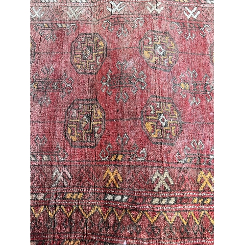 119 - A vintage Bokhara red rug - approx. 103cm x 70cm