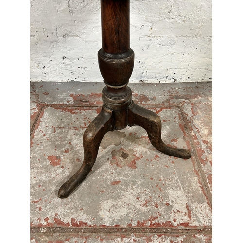 121 - A 19th century carved oak circular tripod pedestal occasional table - approx. 72cm high x 67cm diame... 