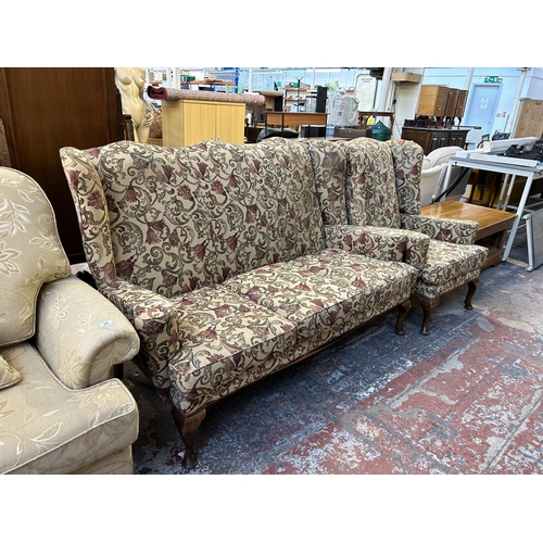 123 - A Georgian style floral upholstered wingback two piece lounge suite comprising three seater sofa and... 