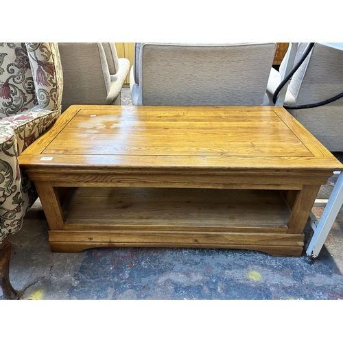 124 - A modern solid oak rectangular two tier coffee table - approx. 46cm high x 60cm wide x 110cm long